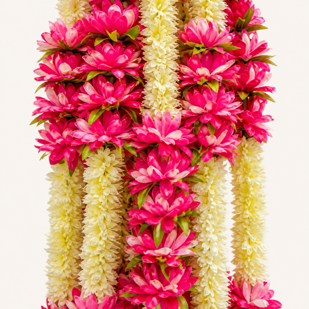 Close-up of pink and cream artificial flowers with green accents