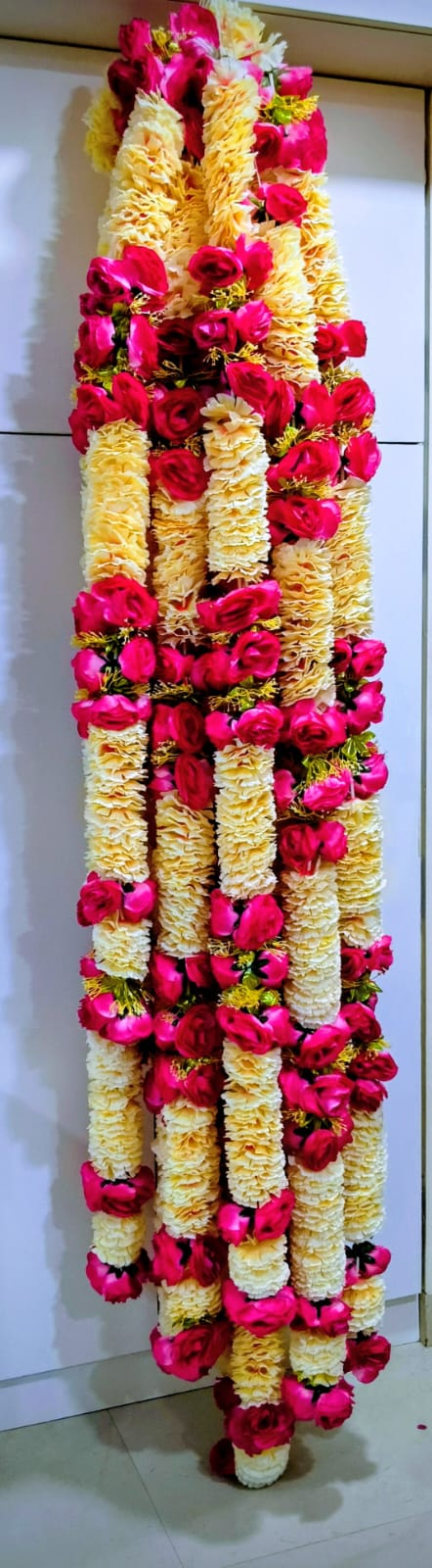 Full-length close view of multicolour cream and magenta artificial flower garland